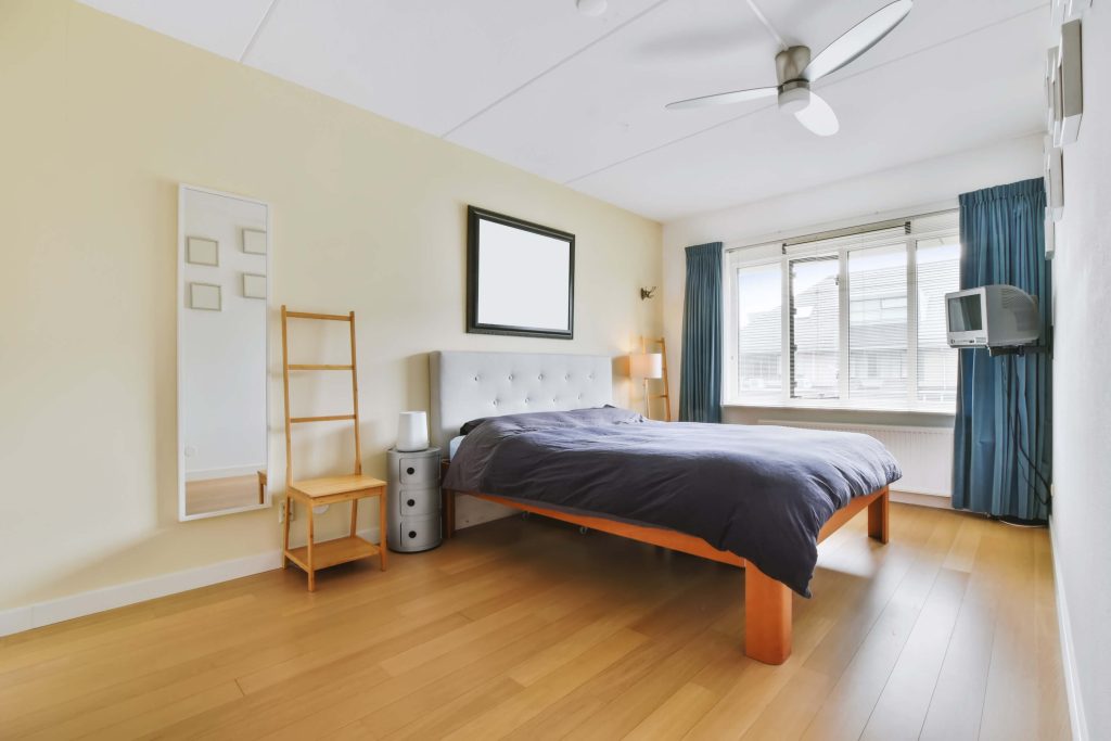 Large bedroom featuring high-quality hardwood flooring